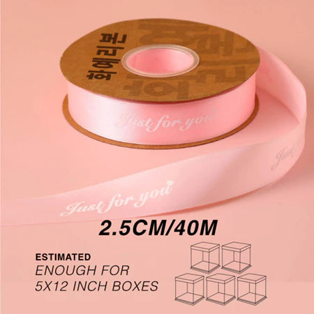 Roll of pink ribbon with a wooden spool on a pink background